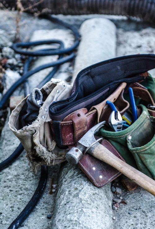 toolbelt-with-tools-on-construction-site